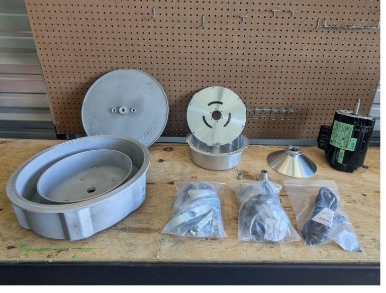 Unpackaged centrifuge parts laid out on a pegboard workbench