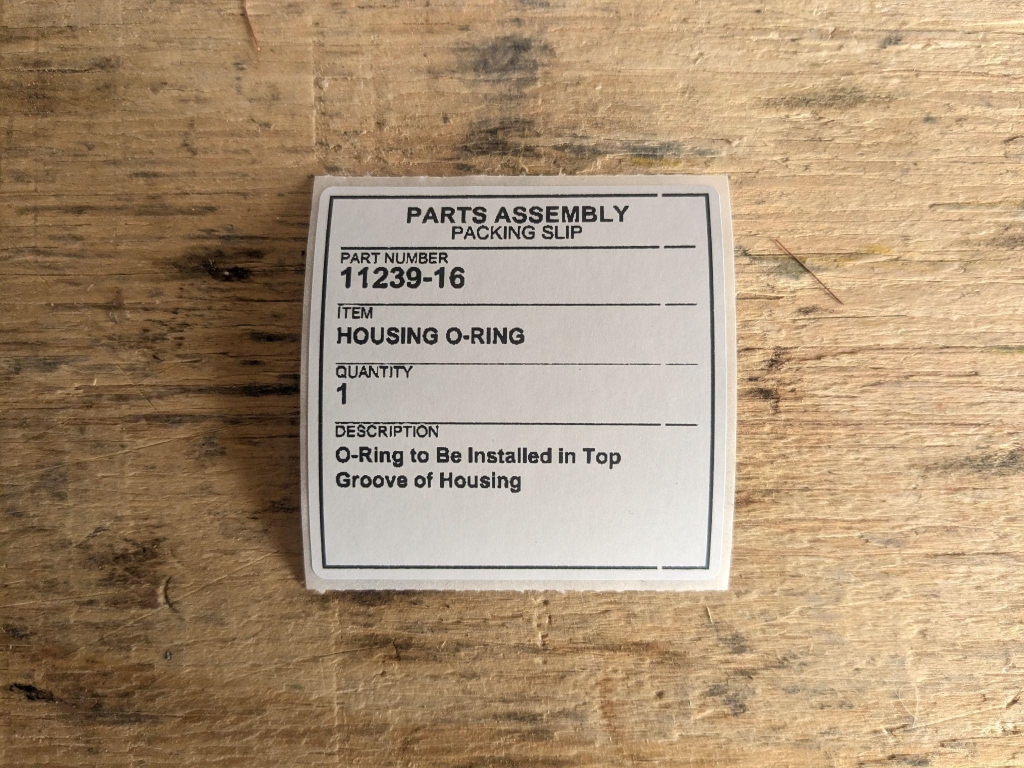 Parts assembly packing slip label showing part number and description