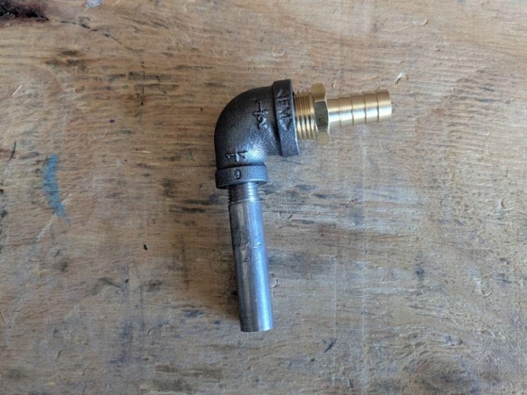 Assembled inlet fitting with hose barb