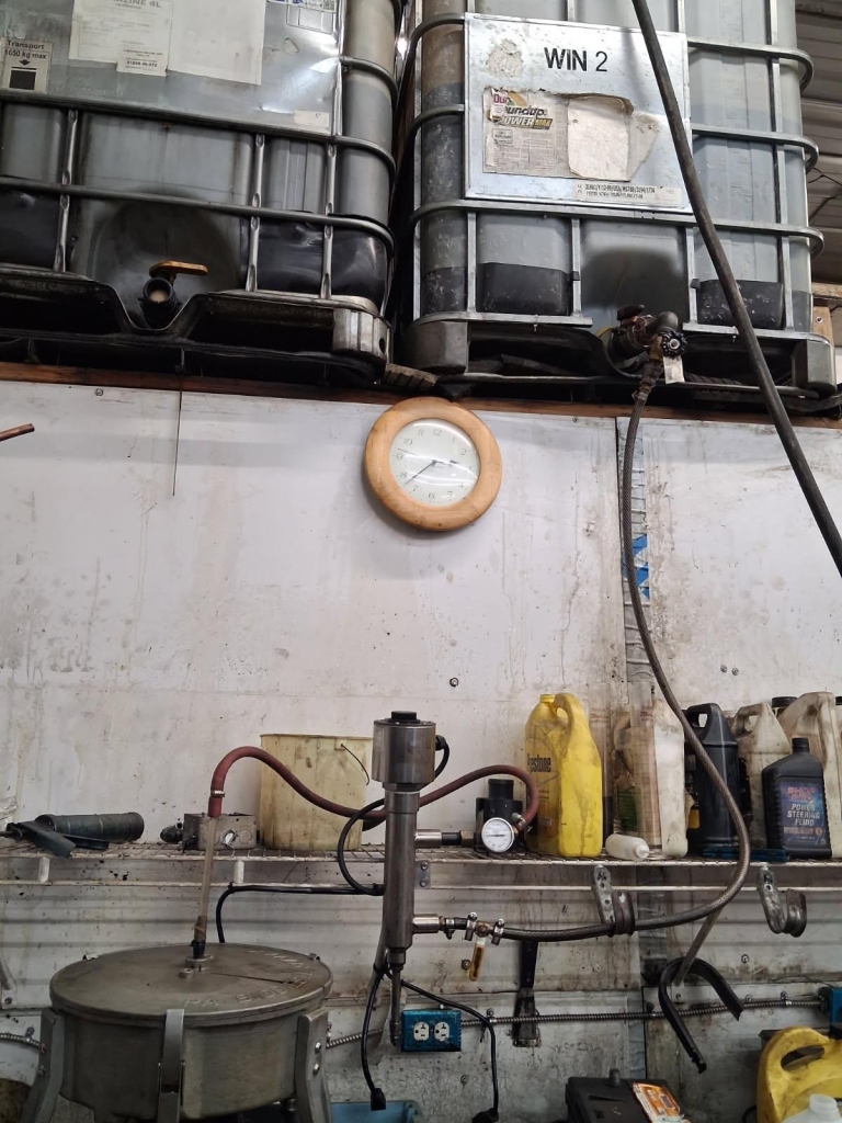 Example gravity-feed shelving setup with IBC totes on a wall rack